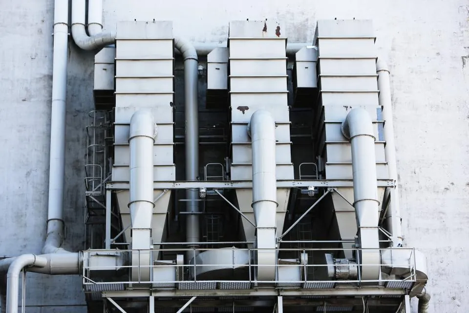 Industrial ductwork and ventilation pipes on a building wall