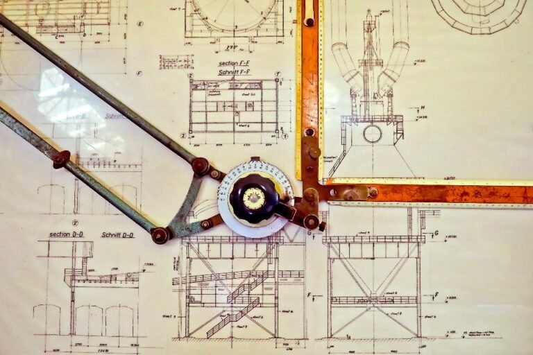 Drafting compass resting on a technical floor plan