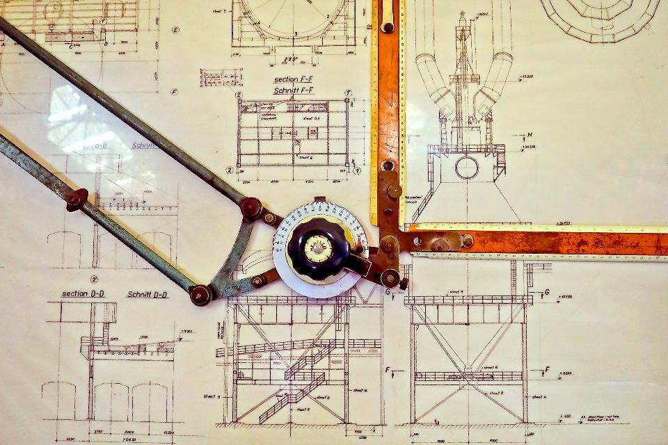 Drafting compass resting on a technical floor plan