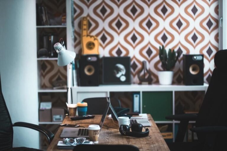 Designer workspace with desk lamp and patterned wall