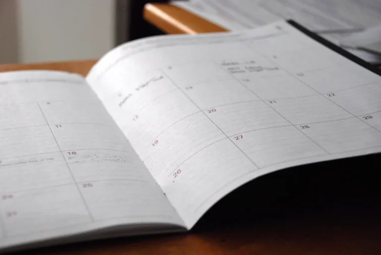 Open monthly calendar and notes on a desk