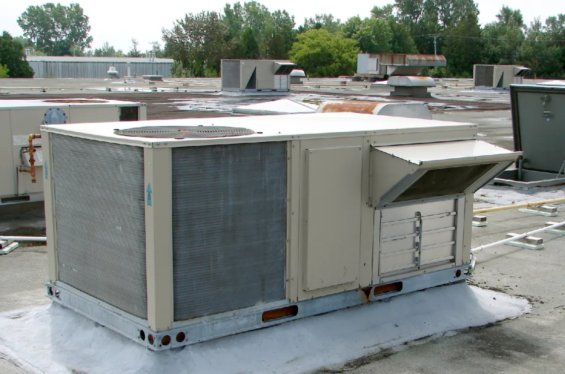 Rooftop packaged heating and cooling units on a commercial roof